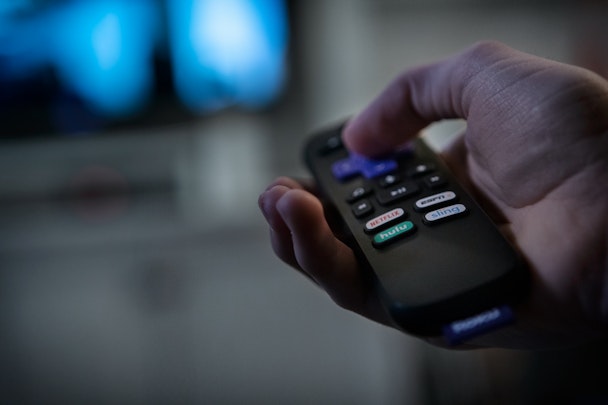 A consumer using a smart television to stream entertainment A consumer using a smart television to stream entertainment