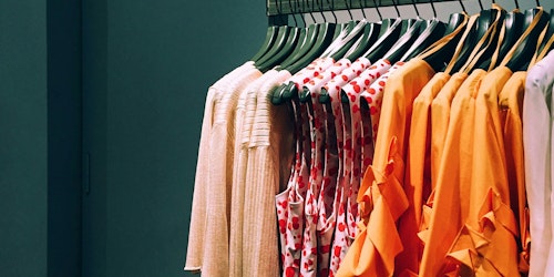 Red and orange clothes on a clothing rail Red and orange clothes on a clothing rail