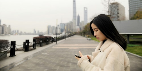 A Chinese woman on a mobile phone in China A Chinese woman on a mobile phone in China
