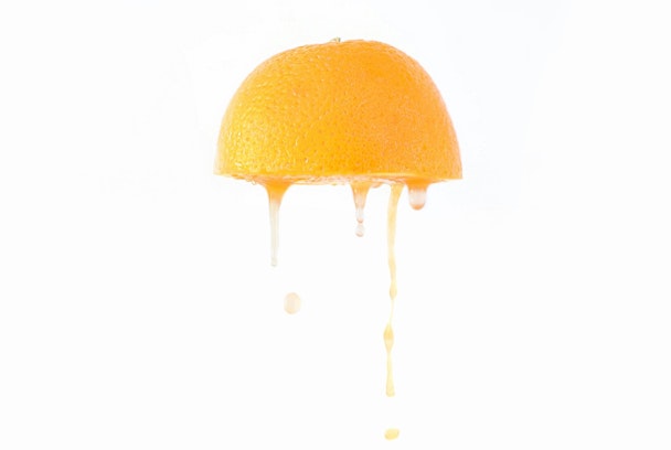Juice drips from an orange half Juice drips from an orange half
