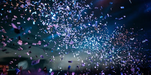 Fans at a festival, under a shower of paper money Fans at a festival, under a shower of paper money