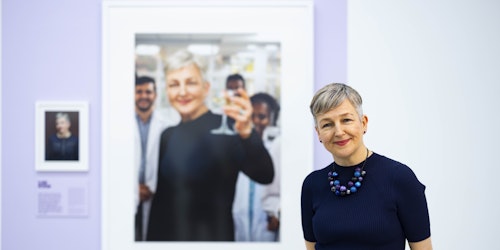 A woman with her portrait at the Saatchi gallery A woman with her portrait at the Saatchi gallery