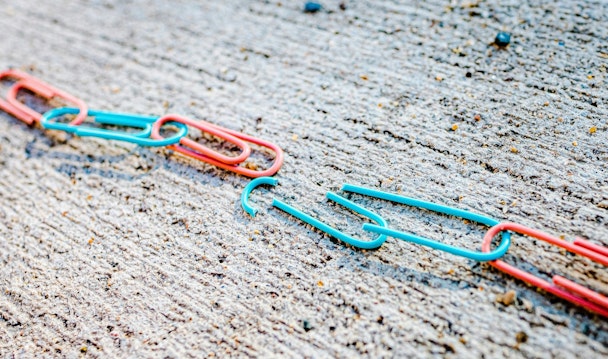A broken chain of blue and red paperclips A broken chain of blue and red paperclips