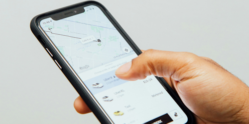 Uber app open on man's mobile phone Uber app open on man's mobile phone