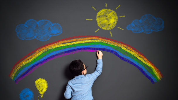 A child draws on a wall in chalk A child draws on a wall in chalk