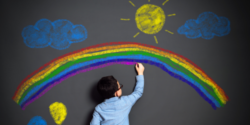 A child draws on a wall in chalk A child draws on a wall in chalk