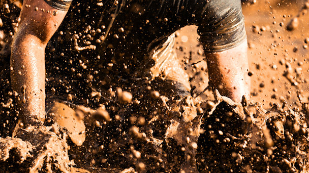 Man runs through a muddy marathon Man runs through a muddy marathon