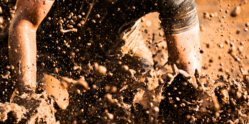 Man runs through a muddy marathon Man runs through a muddy marathon